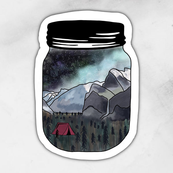 camping in the mountains scene depicted in a mason jar